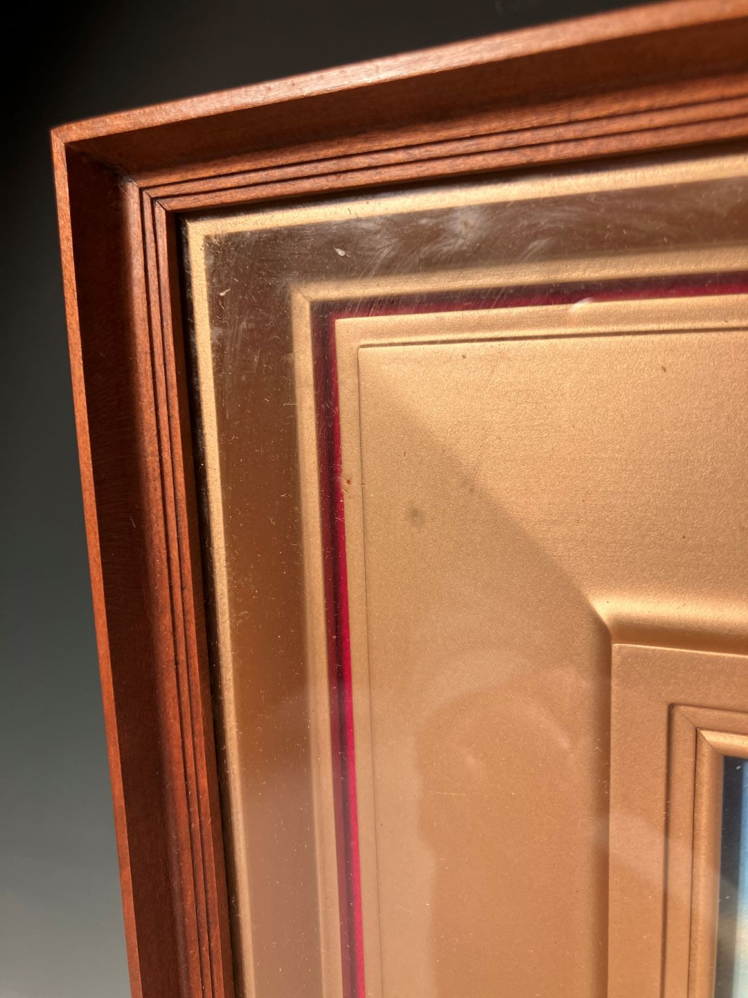 Close-up of a gold frame with a dark background