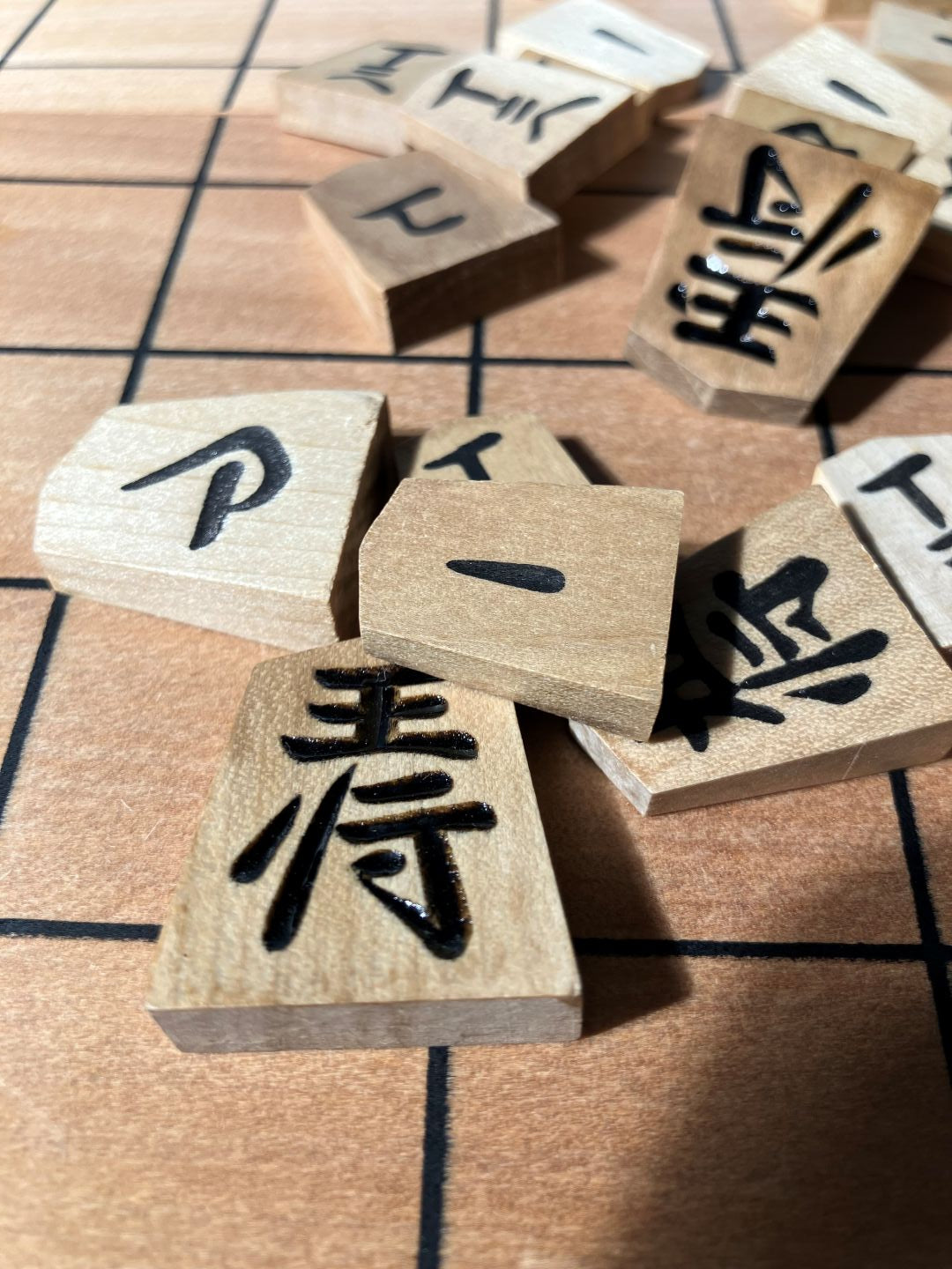 Wooden tiles with Chinese characters on a traditional game board