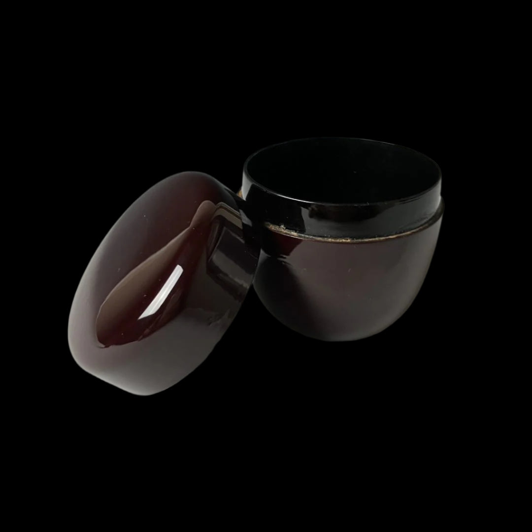 An open 19th-century Japanese lacquered makie natsume tea caddy in deep brown, displaying its smooth finish and meticulous craftsmanship, exemplifying the elegance and tradition of Japanese tea ware.