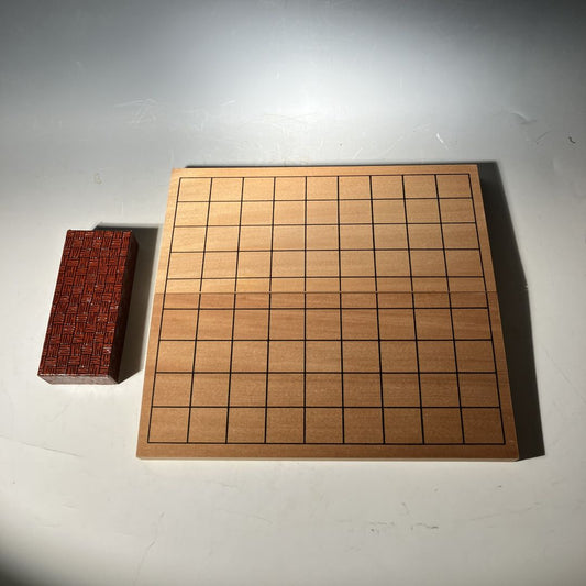 Wooden chessboard with a red piece on a gray surface