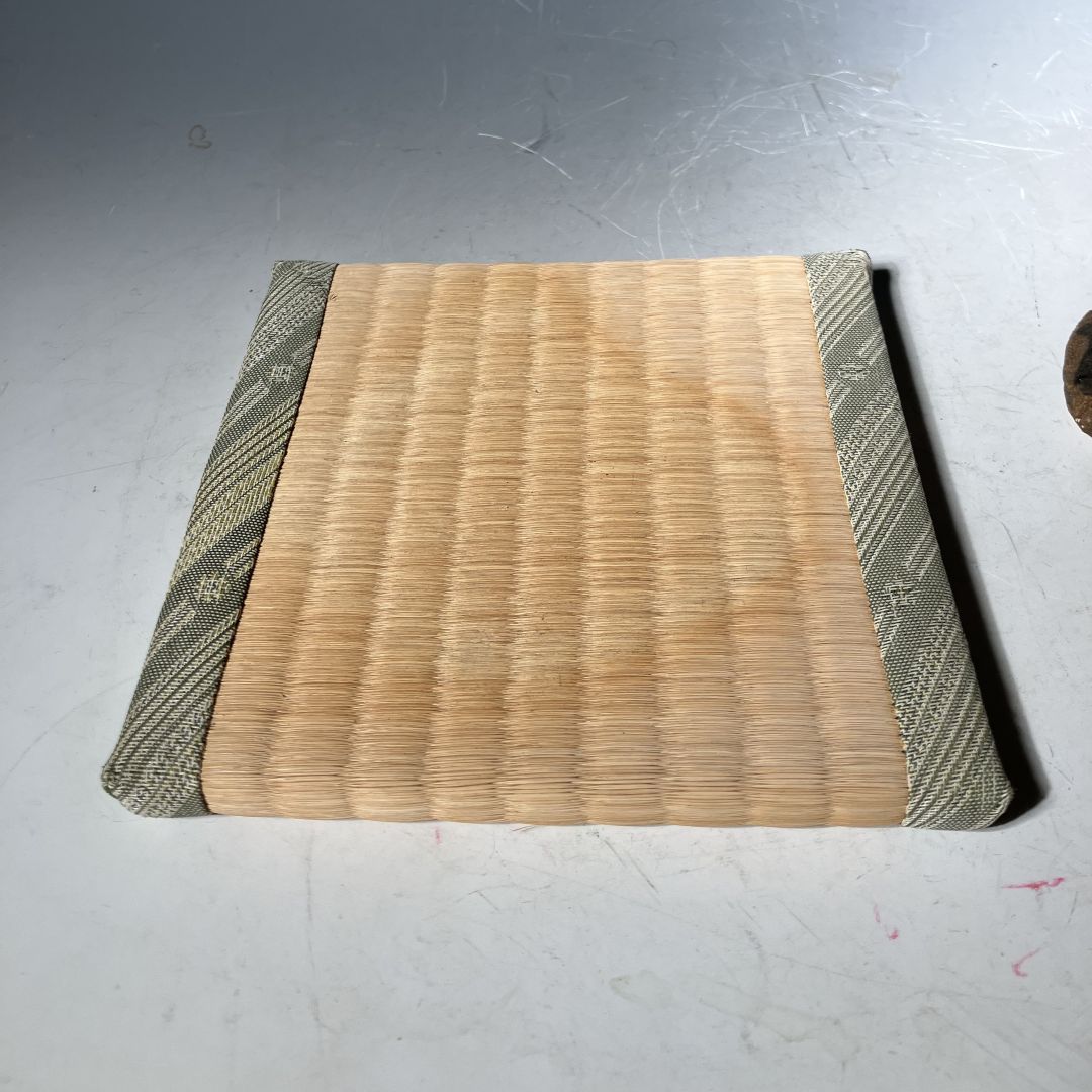Wooden cutting board with green edges on a gray surface