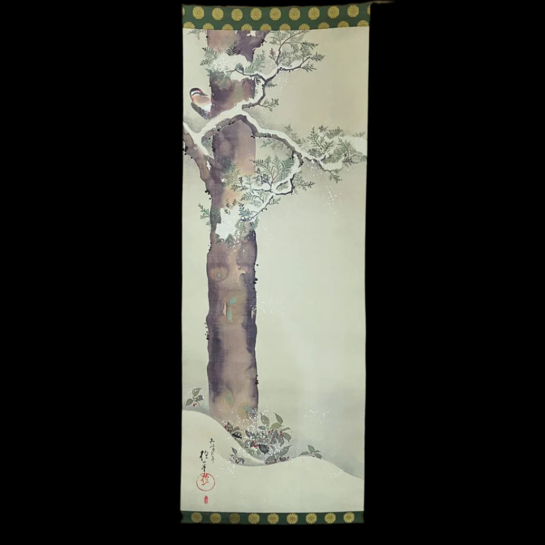 A traditional East Asian scroll painting featuring a plum tree with white blossoms, framed by a decorative border, against a patterned beige backdrop.