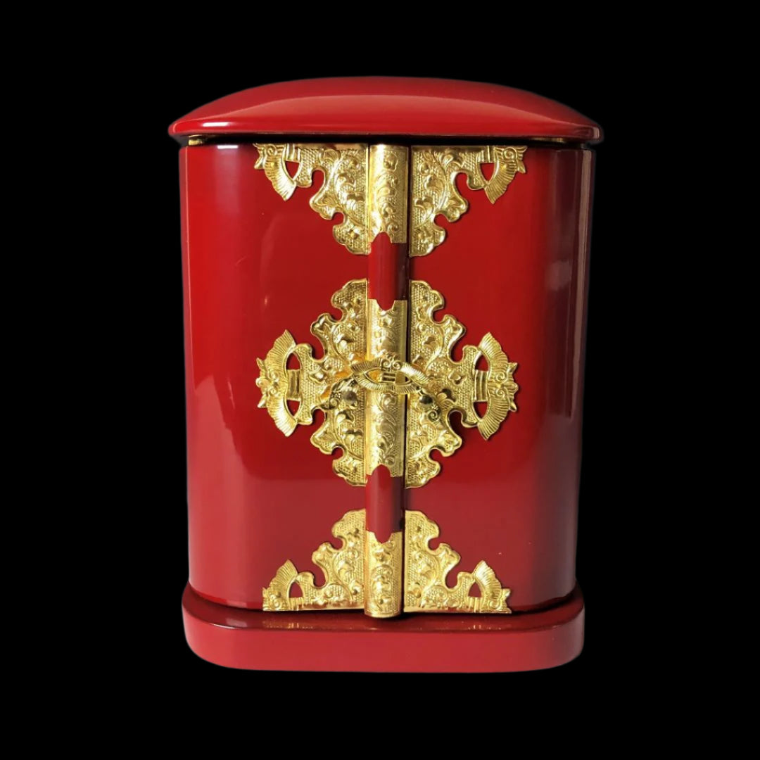 A closed Japanese vintage Zushi cabinet with a vibrant red finish and ornate golden metalwork on the hinges and clasps, displaying traditional design elements.