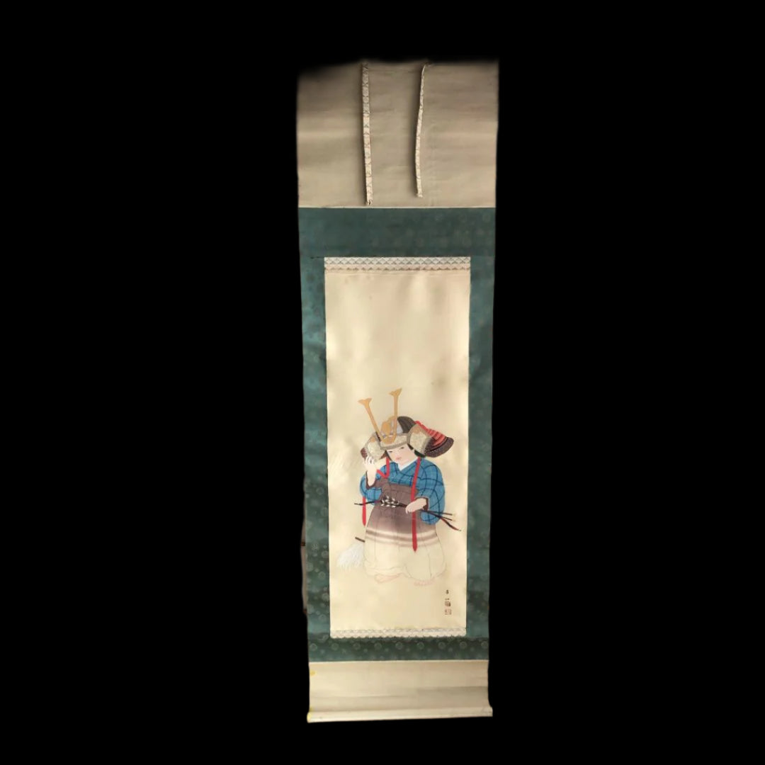 A Japanese art roll painting of child with a helmet in a tatami room