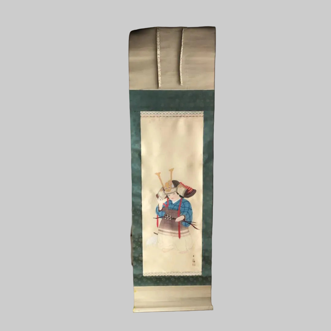 A Japanese art roll painting of child with a helmet in a tatami room