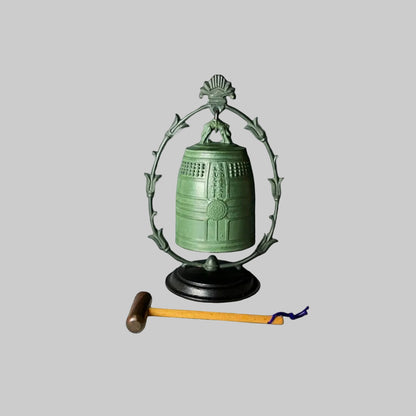 Japanese vintage metal gong with a bronze finish, mounted on a wooden stand, accompanied by a wooden stick with a yellow tip.