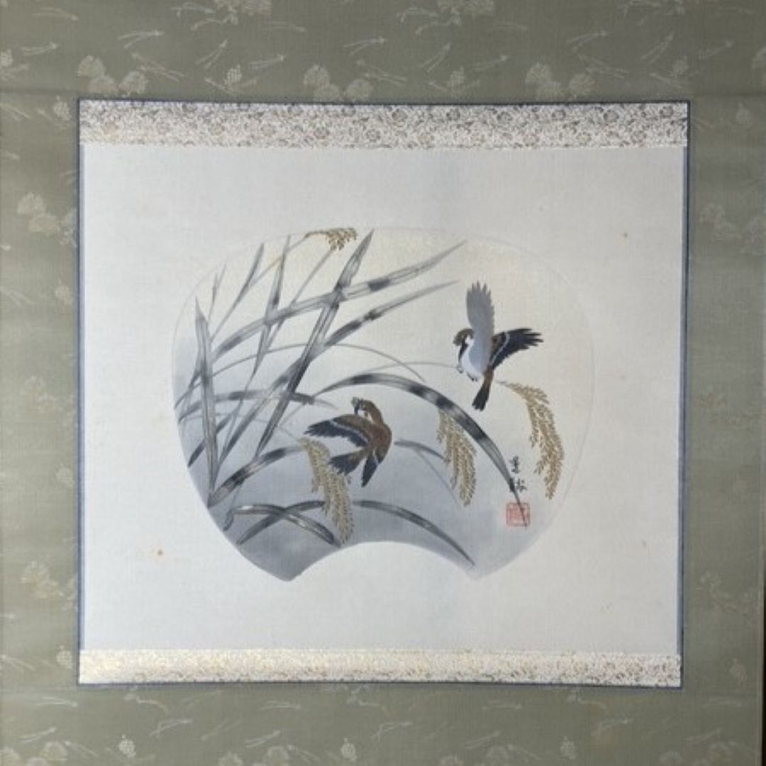 Framed artwork of birds and plants on a light background
