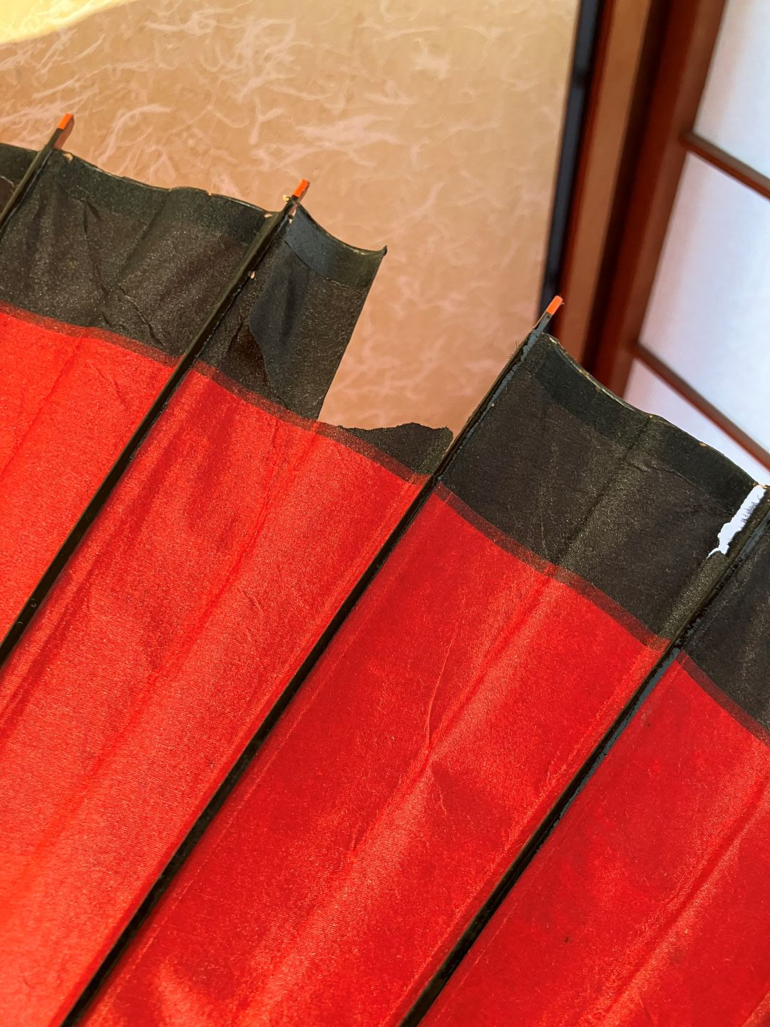 Close-up of a red and black fabric with a textured background