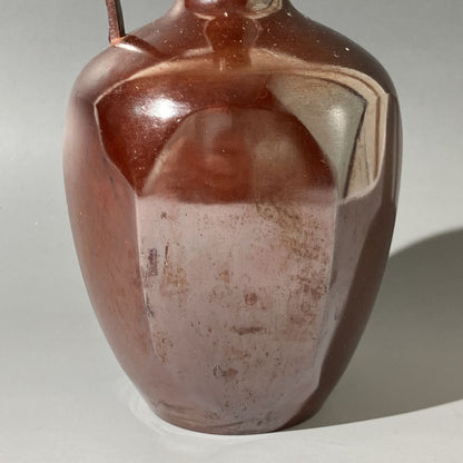 Brown ceramic vase on a light gray background