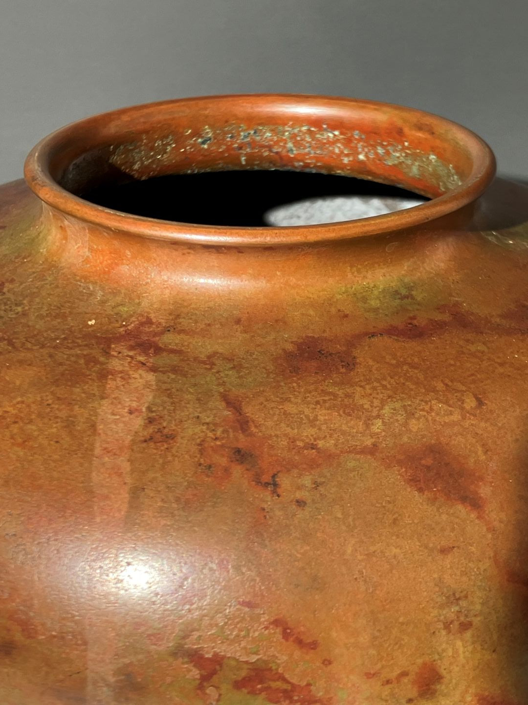 Close-up of a ceramic pot with a textured surface on a gray background