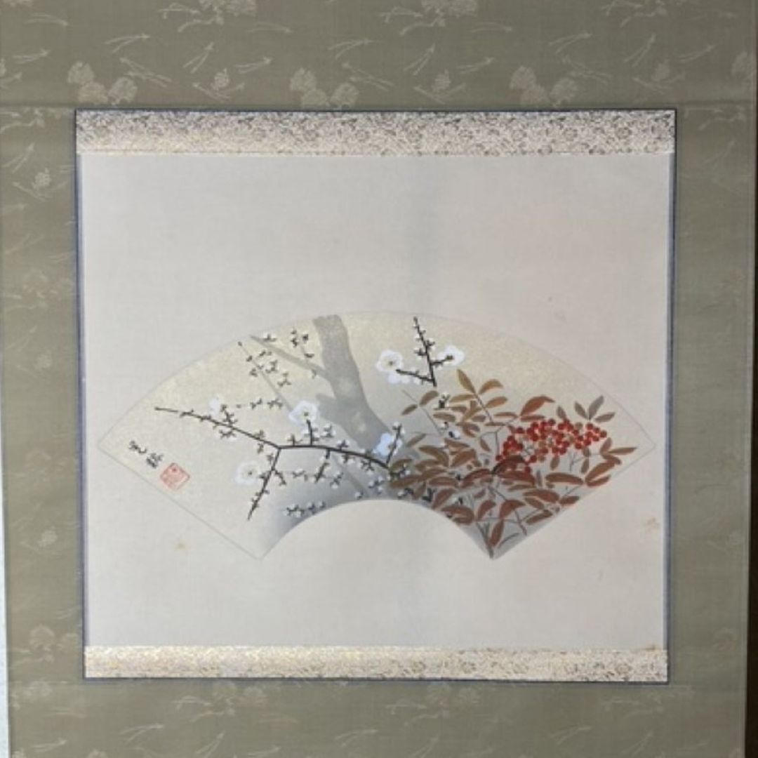 Framed artwork of a traditional Japanese fan with floral and branch design.
