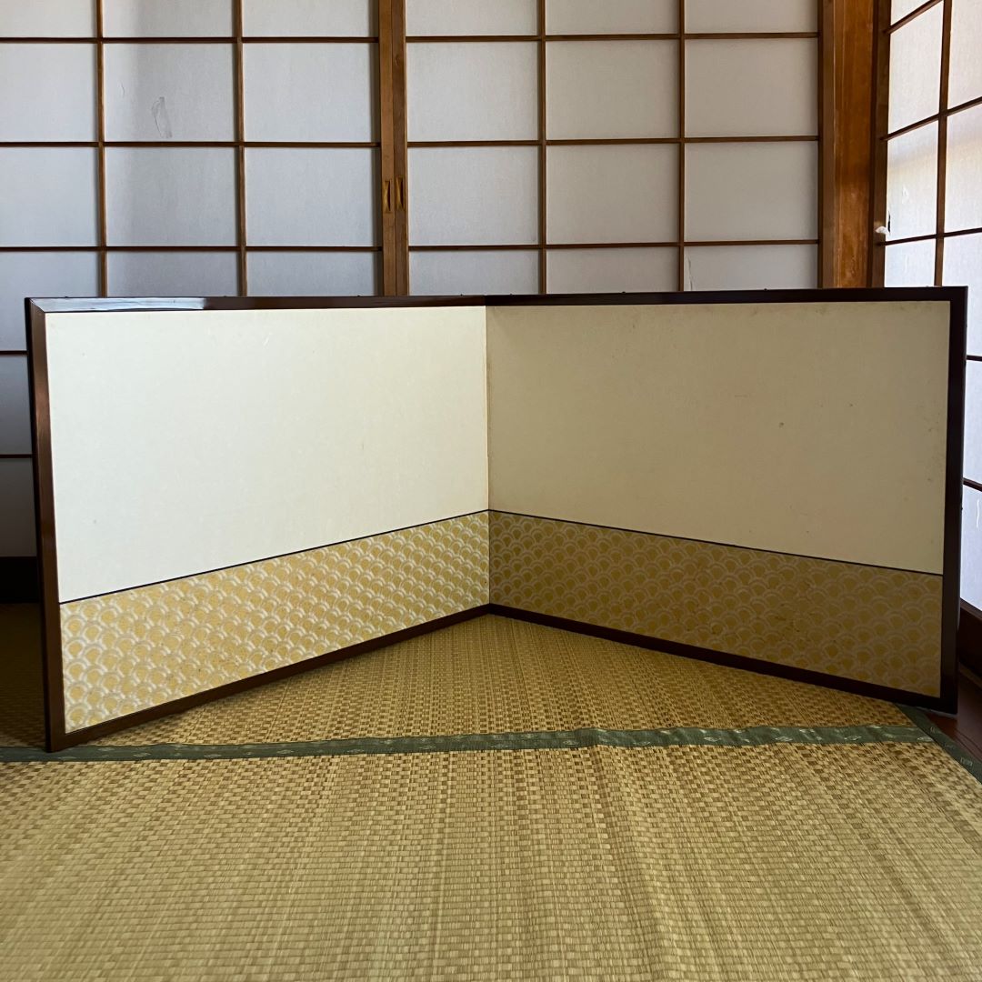 Traditional Japanese room with tatami flooring and sliding doors.