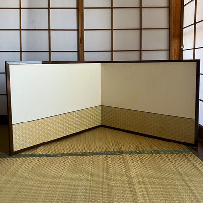 Traditional Japanese room with tatami flooring and sliding doors.