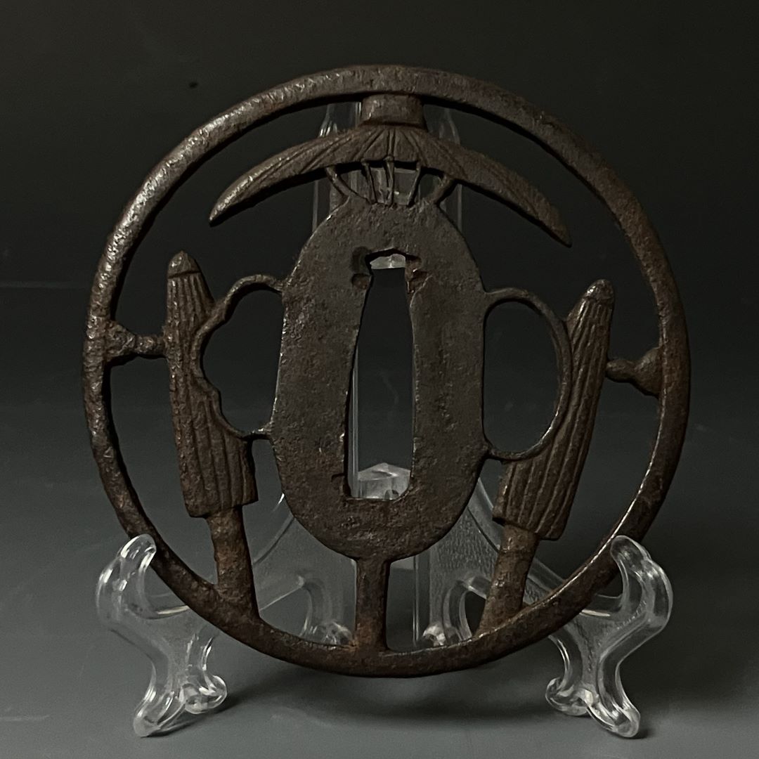 Decorative metal piece on a stand against a dark background