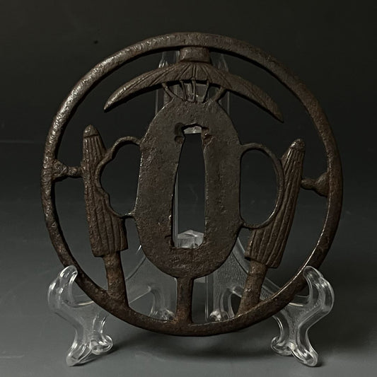 Decorative metal piece on a stand against a dark background