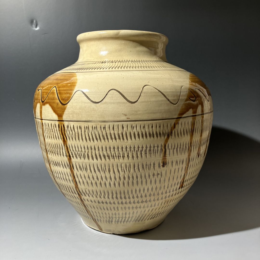 Ceramic vase with decorative patterns on a gray background