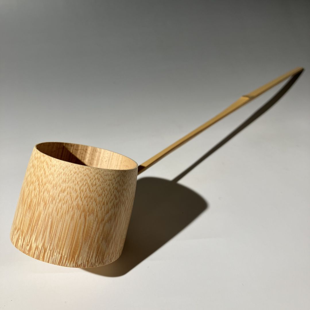 Wooden ladle on a gray background