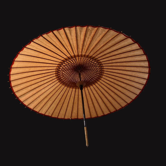 Traditional Japanese umbrella on a tatami mat floor with sliding doors in the background