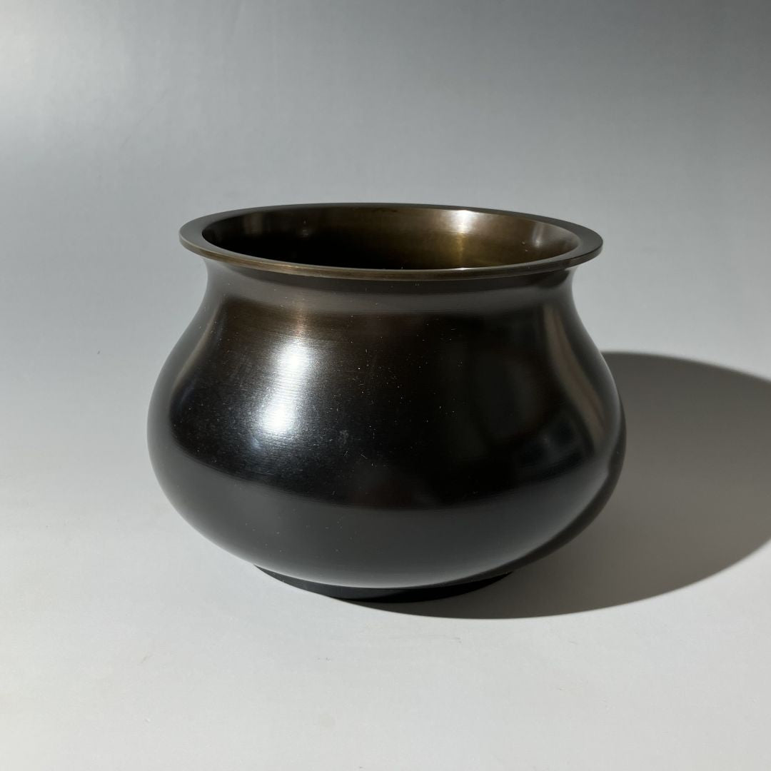 Bronze pot on a gray background