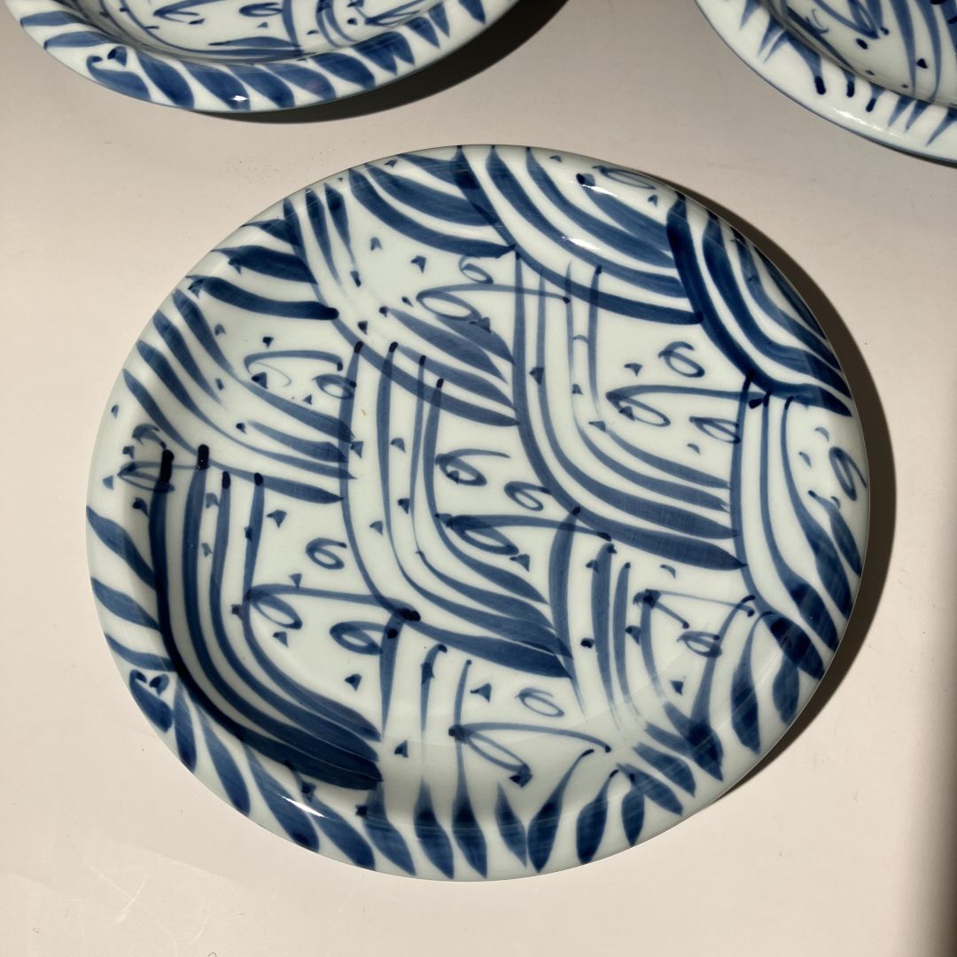 Ceramic plate with blue abstract pattern on a beige background