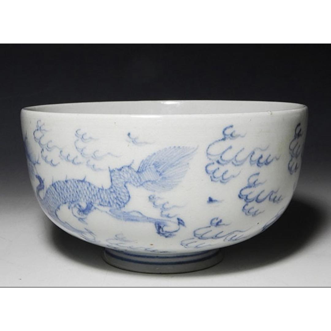 19th-century Ko-Imari white ceramic bowl with a detailed blue dragon and cloud pattern, a fine example of traditional Japanese blue and white porcelain.