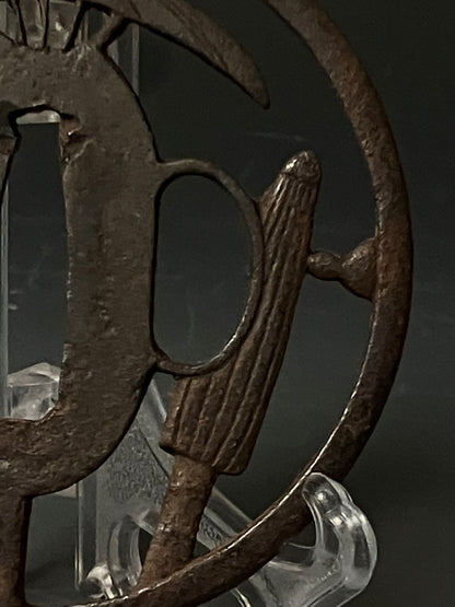 Close-up of a metal emblem with a design on a dark background