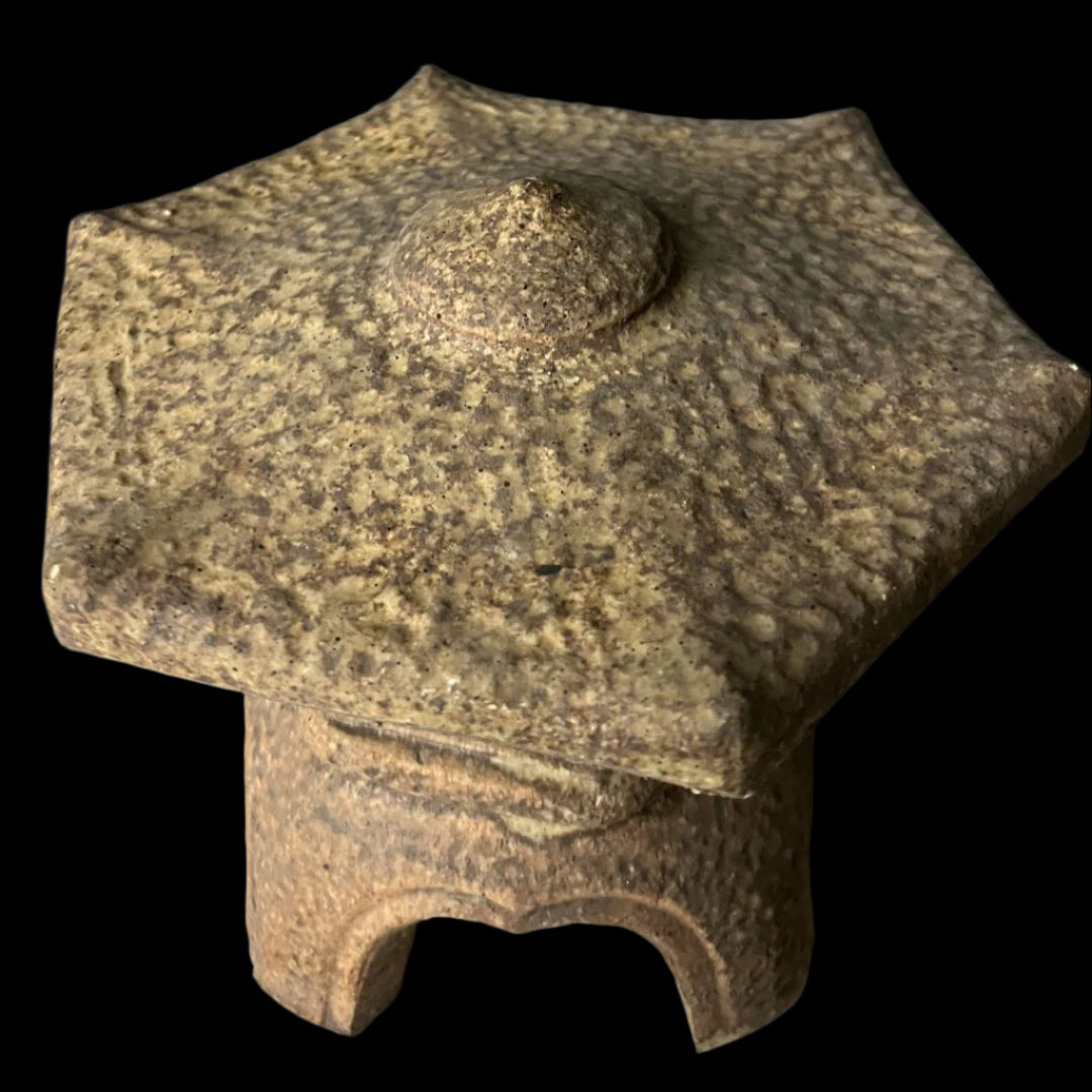 Top view of a vintage Japanese ceramic temple lantern in Ishidoro design, highlighting the textured hexagonal roof and traditional craftsmanship.