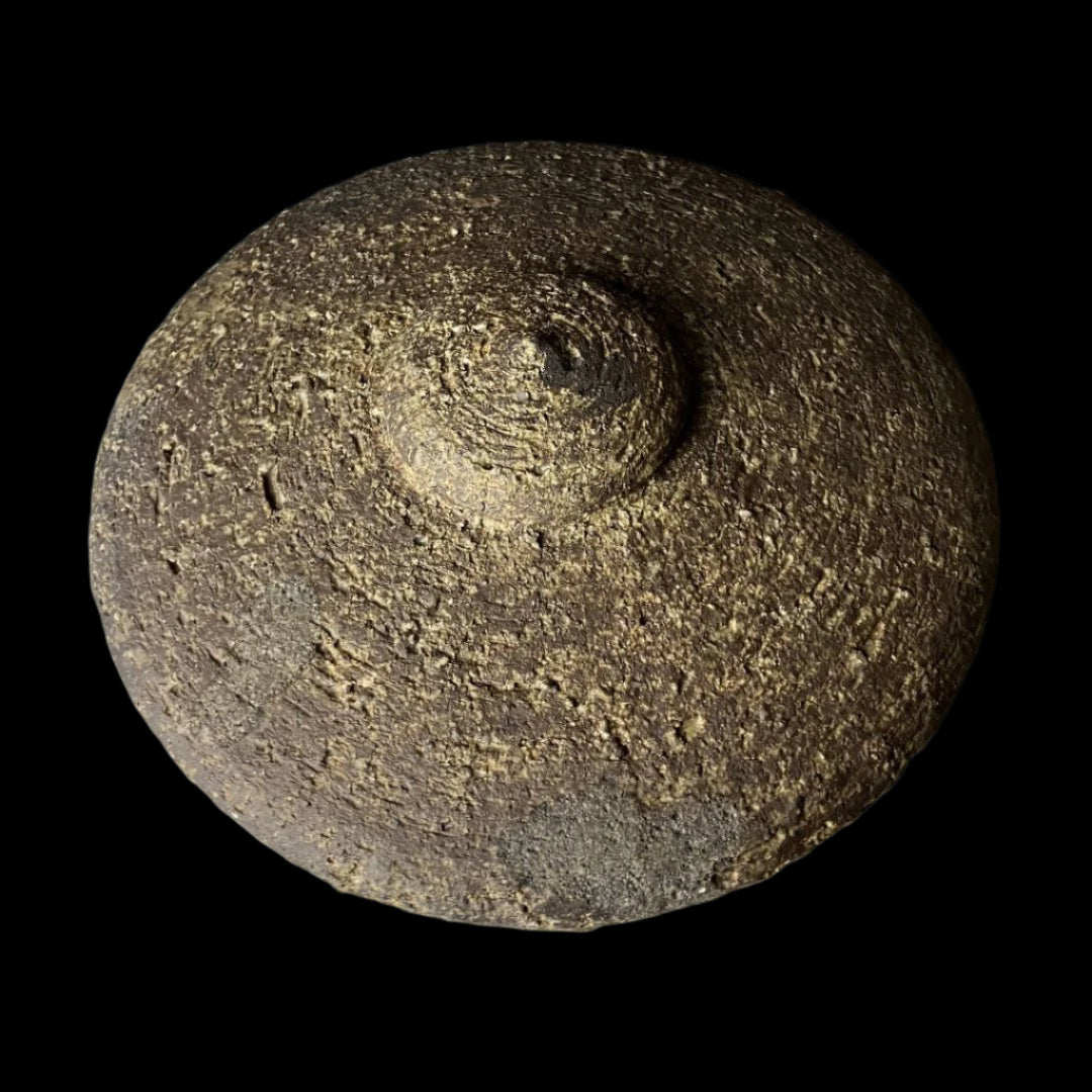 Top view of a vintage Japanese stone lantern, highlighting the textured domed roof and natural weathered surface, exemplifying traditional craftsmanship.