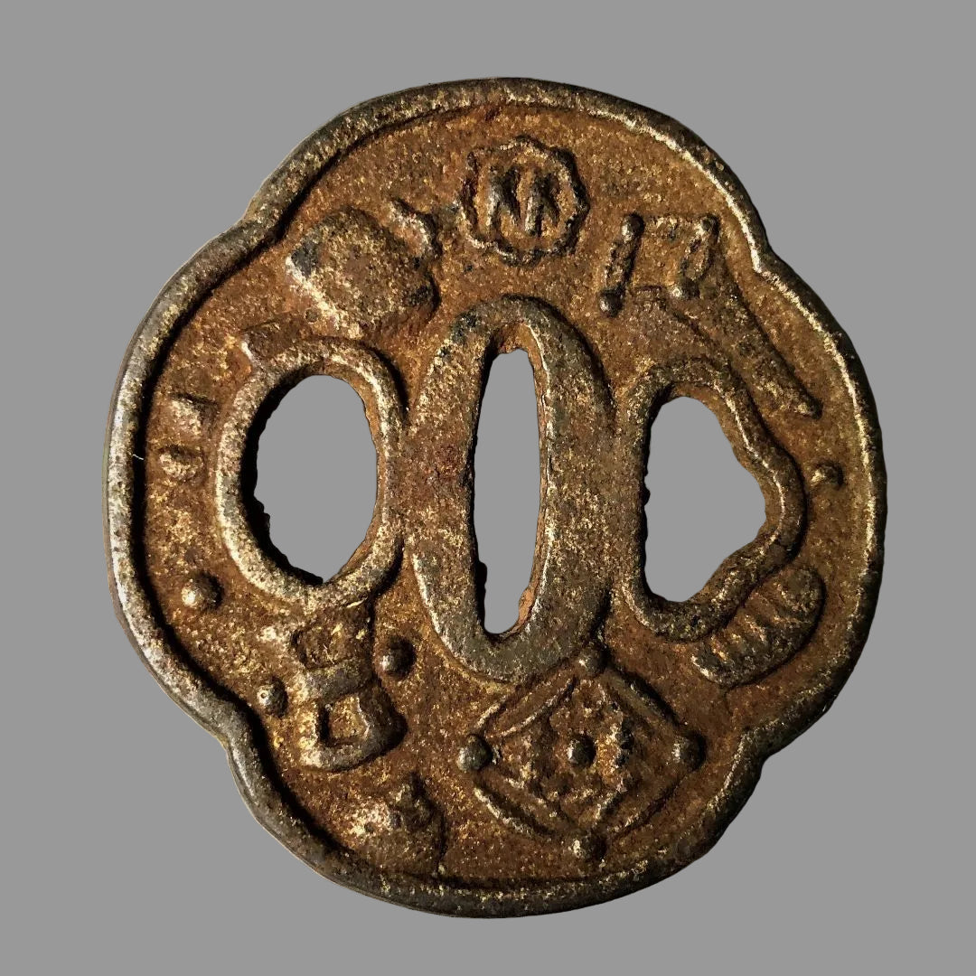 Rust-colored metal tsuba on a gray background