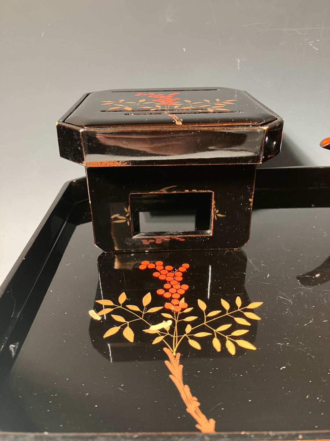 Decorative black box with floral patterns on a gray background