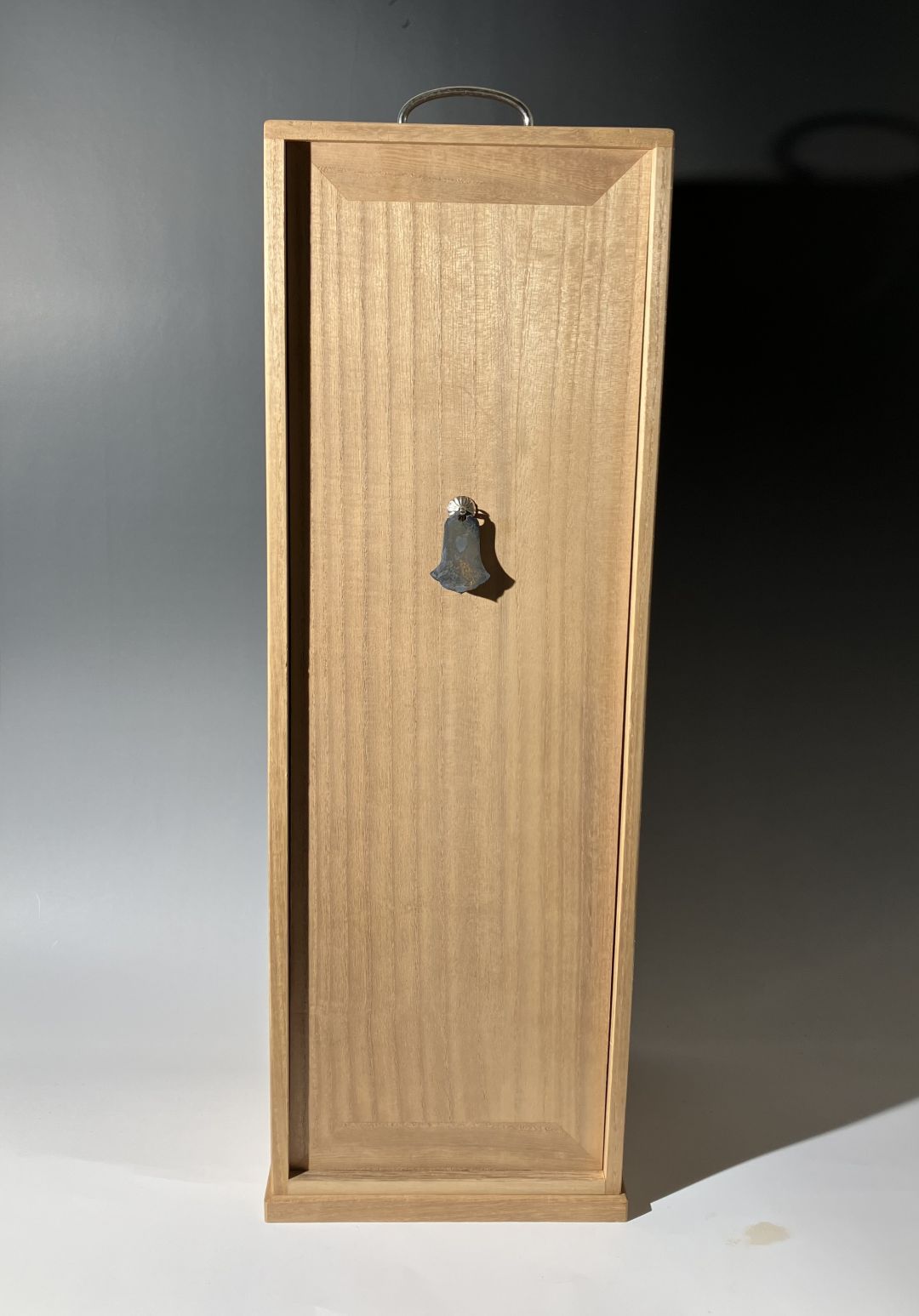 Wooden cabinet with a bell on a gradient background