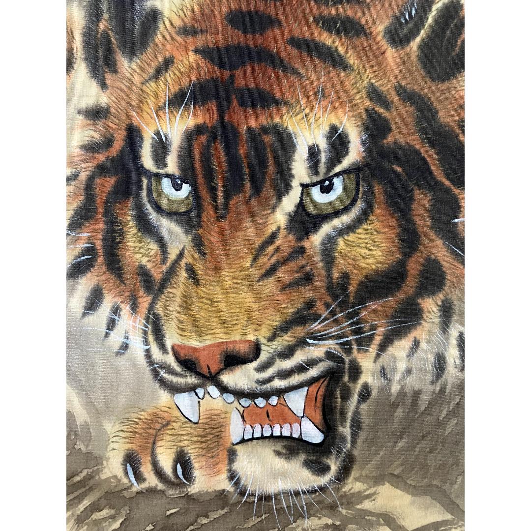 Close-up of a painting showing the intense gaze and snarling mouth of a tiger with detailed fur and whiskers.