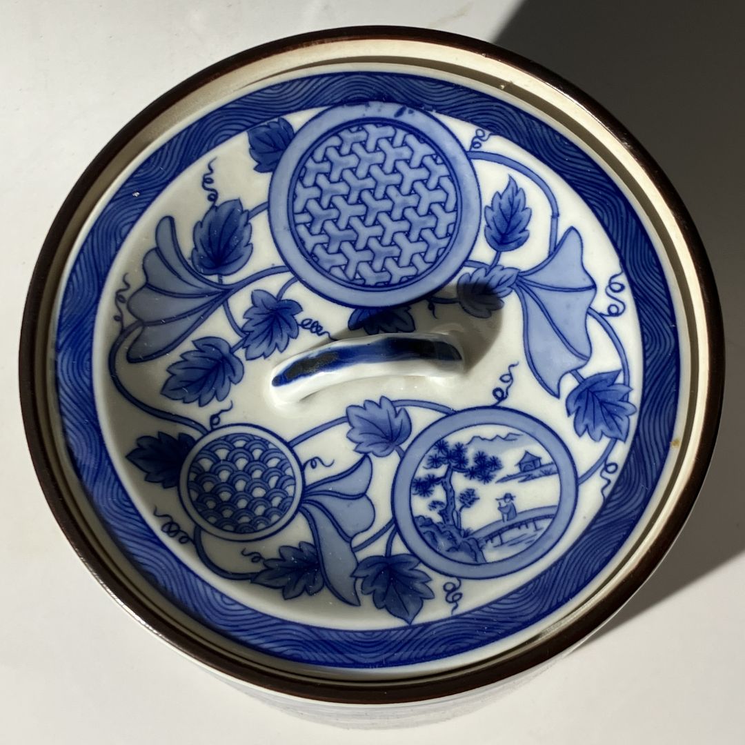Blue and white ceramic dish with intricate patterns on a white background