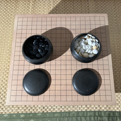 two go bowls on a go board game