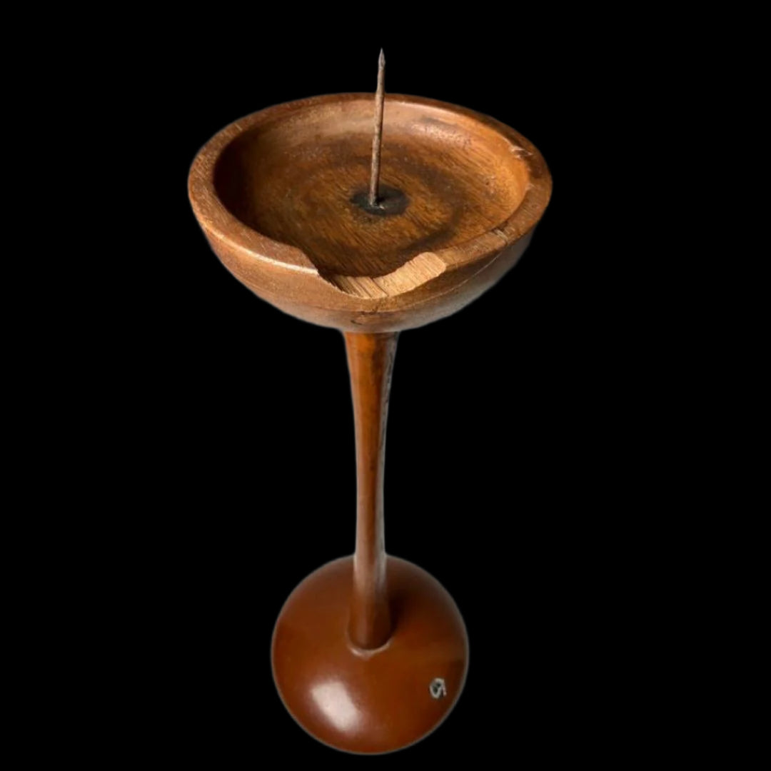 Top view of a vintage Japanese wooden candle stand showcasing its elegant curved design, aged wooden texture, and functional central spike for securing candles.