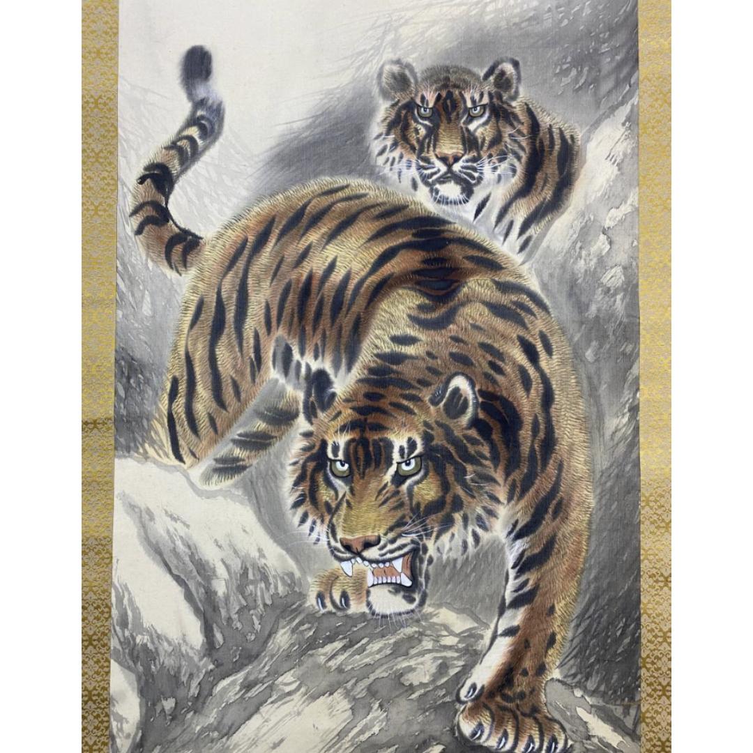 A detailed painting of two tigers, one in the foreground with its mouth open and another behind it, set against a rocky backdrop.