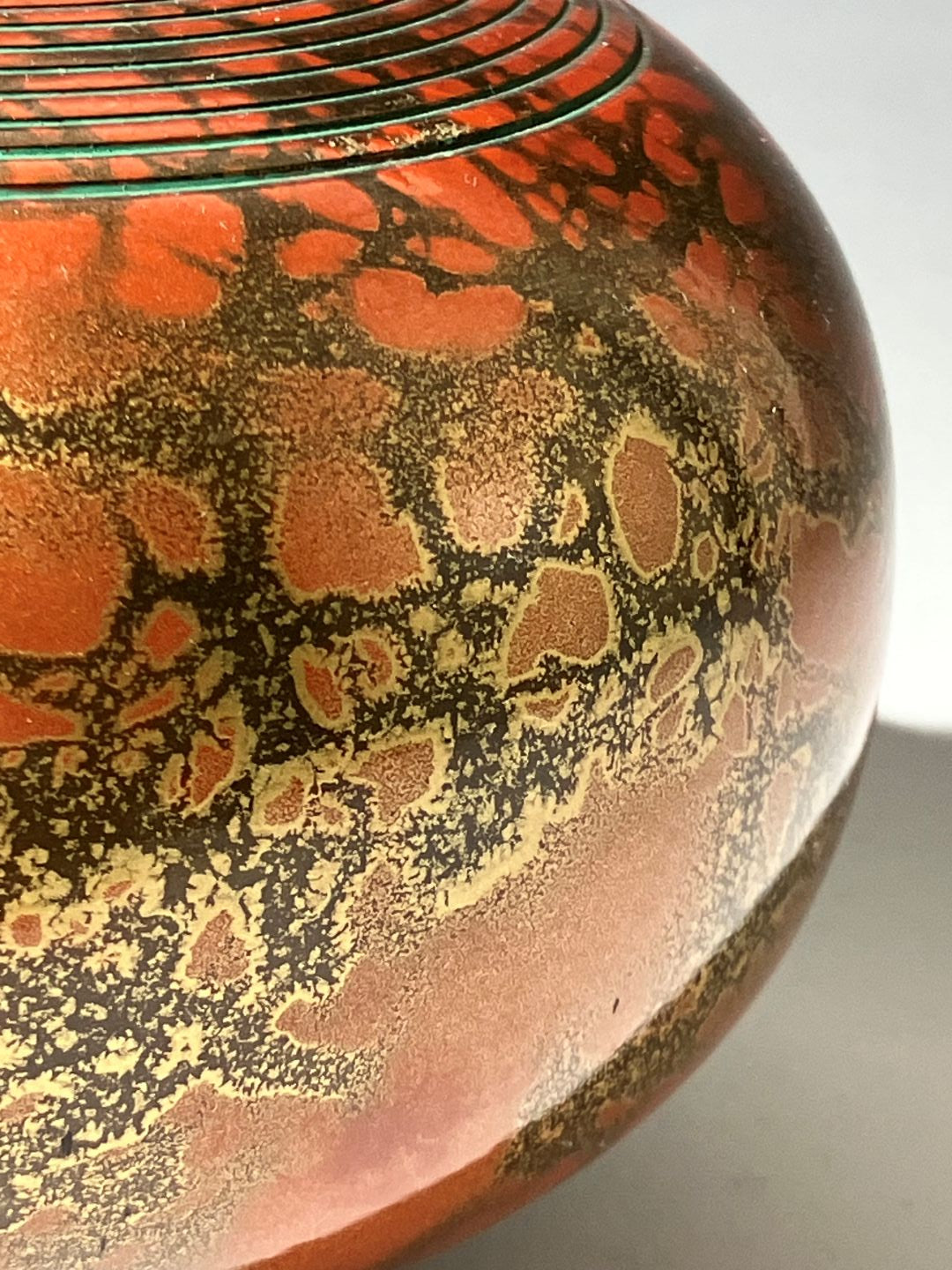 Decorative object with intricate patterns on a red and black background