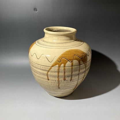 Ceramic vase with decorative patterns on a gray background