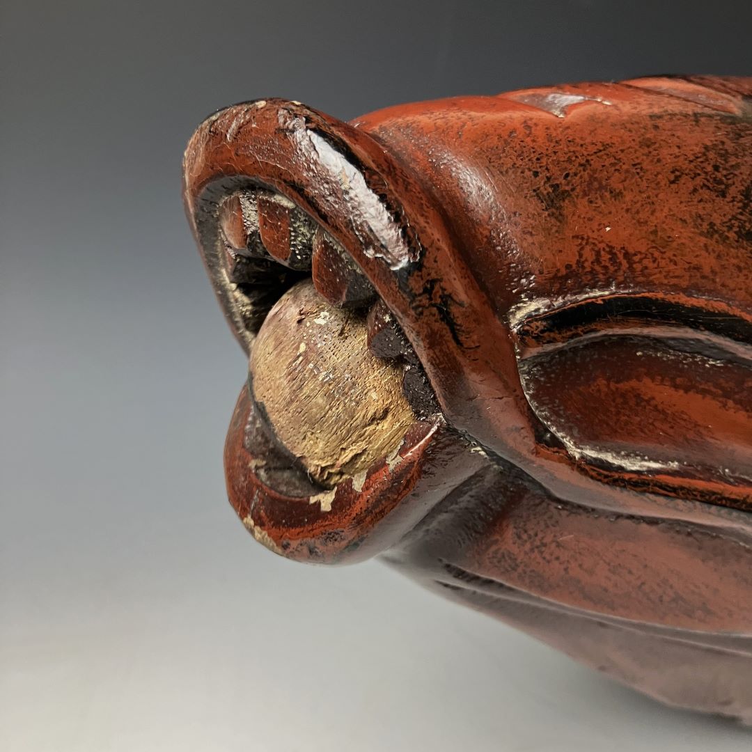Close-up of an aged wooden fish carving mouth and nose detail, displaying chipped paint and a rustic patina indicative of traditional Japanese Jizaikagi craftsmanship.